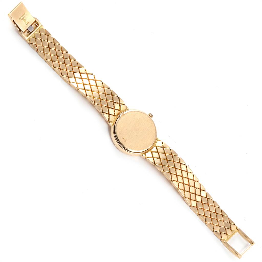 The image shows a top-down view of a Patek Philippe Calatrava 4819 Women's Yellow Gold White Dial 4819 Women's Yellow Gold White Dial watch with a gold mesh strap.