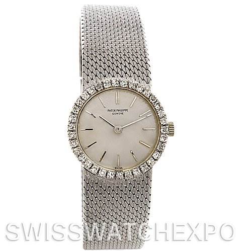 This image shows a frontal view of a Vintage Patek Philippe watch, highlighting its mesh bracelet, round face, and diamond bezel.