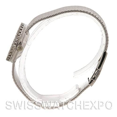 The image shows a side angle of a Vintage Patek Philippe watch, highlighting the case, crown, and metal bracelet.