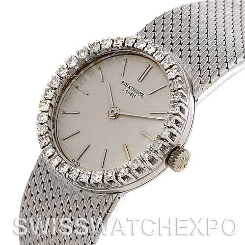 The image shows a Vintage Patek Philippe watch at a slightly tilted angle, featuring the face, crown, and part of the metal mesh strap.