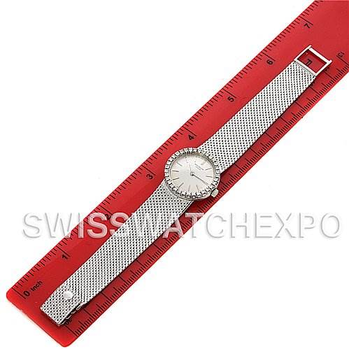 This image shows a top-view angle of a Vintage Patek Philippe watch, placed along a red ruler for scale, displaying its face and band.