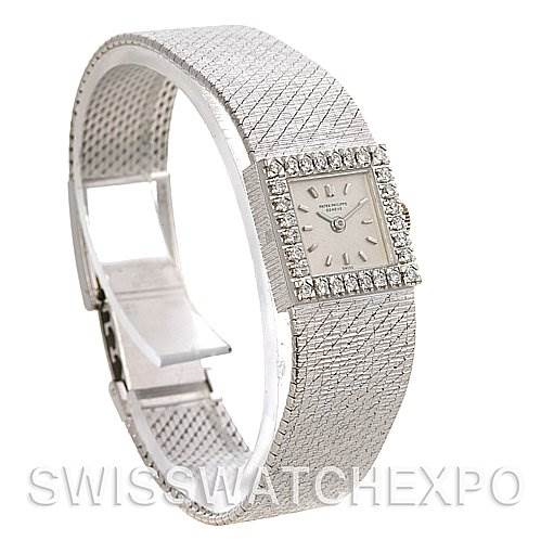 The image shows a side view angle of a Vintage Patek Philippe watch, highlighting its textured bracelet and diamond bezel.
