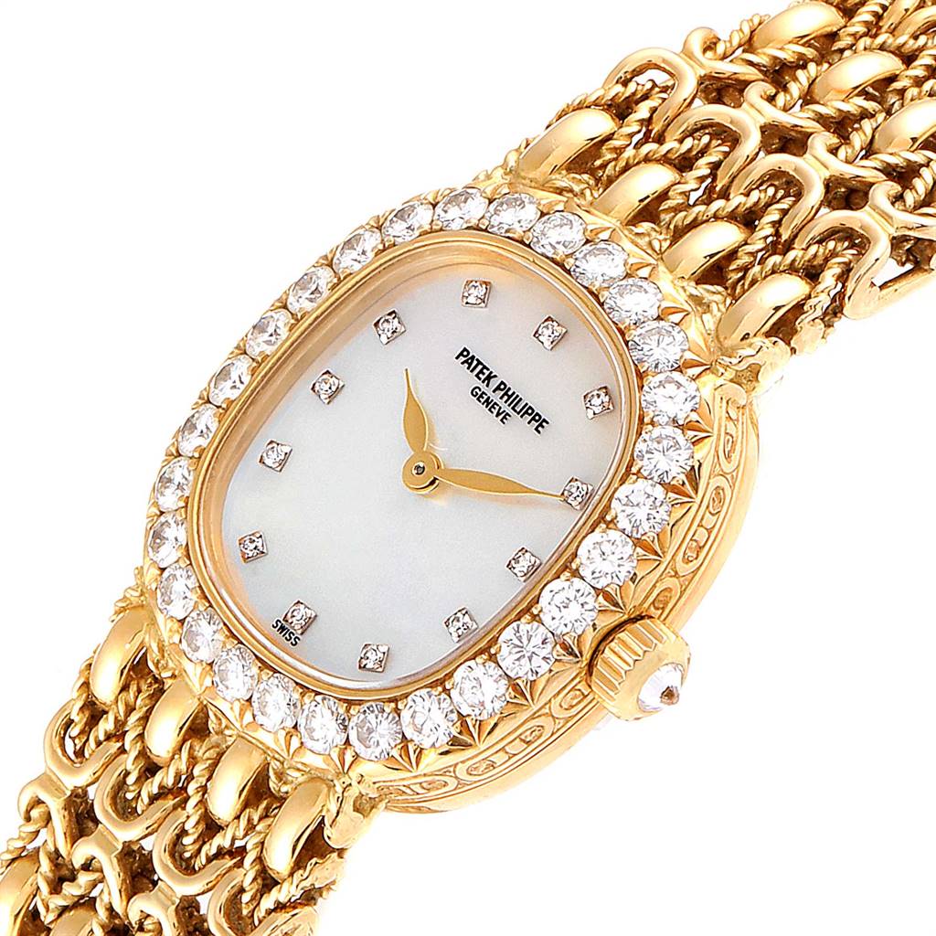 The image shows a close-up of the Patek Philippe Golden Ellipse 4931/2 Women's Yellow Gold Mother of Pearl Dial 4931/2 Women's Yellow Gold Mother of Pearl Dial watch, featuring a diamond-encrusted bezel and golden bracelet.