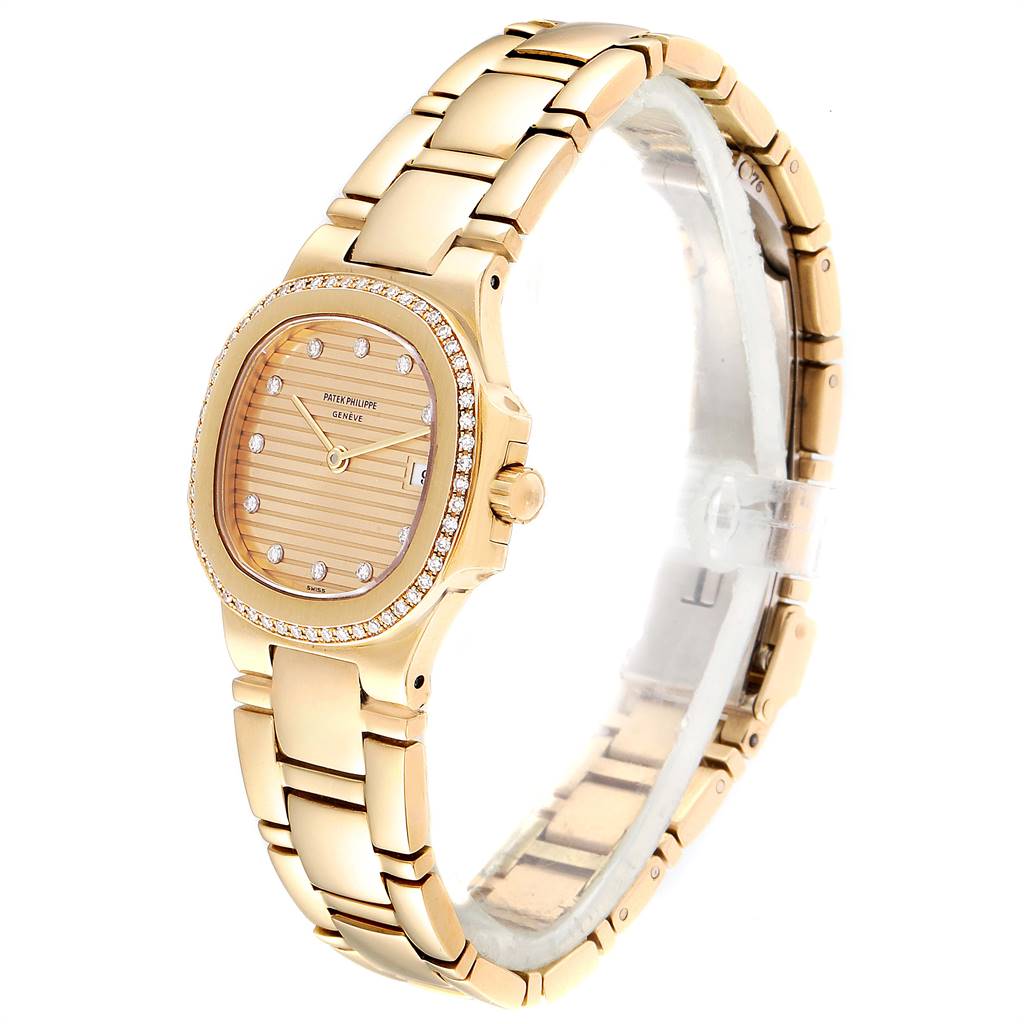 The image shows a Patek Philippe Nautilus 4700 Women's Yellow Gold Champagne Dial 4700 Women's Yellow Gold Champagne Dial watch at a three-quarter angle, highlighting the gold band, bejeweled bezel, and dial.