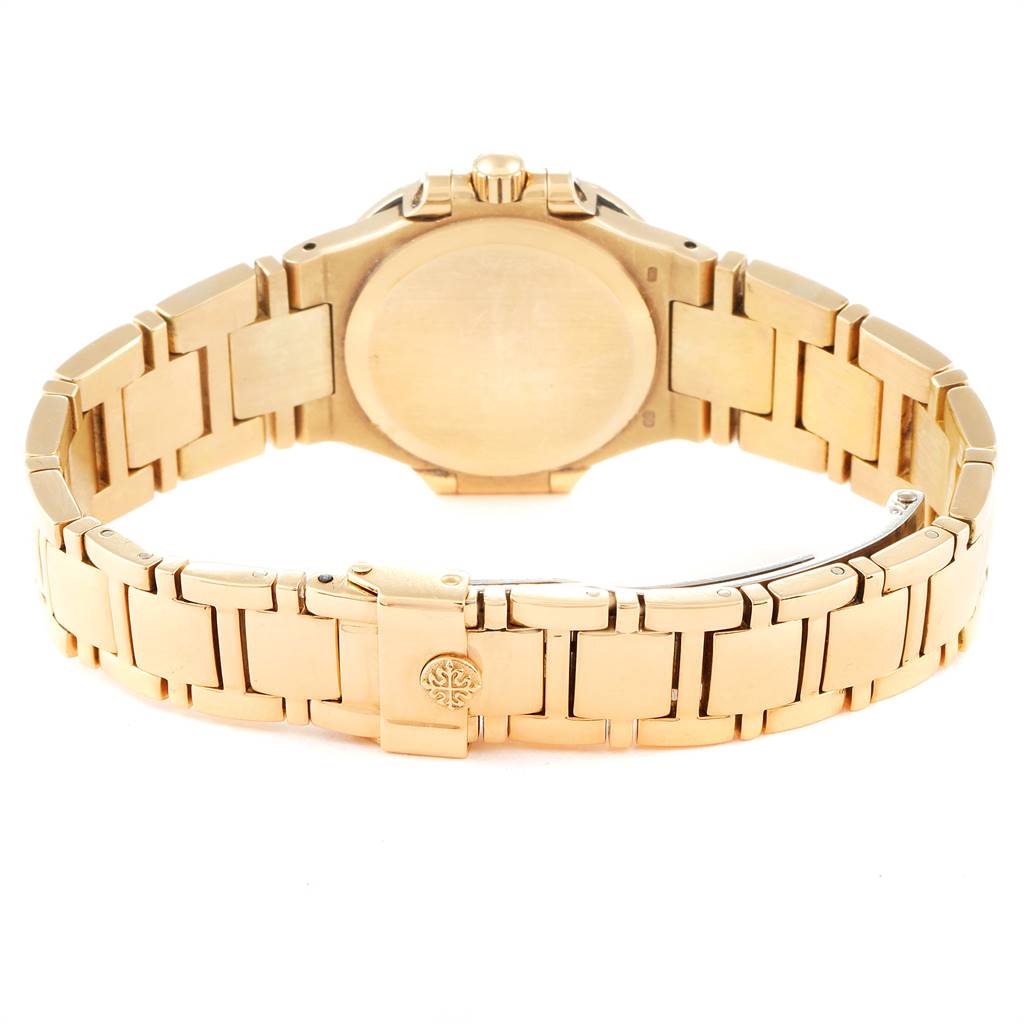 The image shows the back of a Patek Philippe Nautilus 4700 Women's Yellow Gold Champagne Dial 4700 Women's Yellow Gold Champagne Dial watch, highlighting its bracelet and clasp.