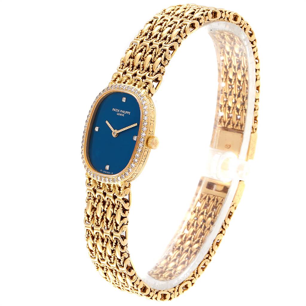 The image shows a Patek Philippe Golden Ellipse 4698/1 Women's Yellow Gold Blue Dial 4698/1 Women's Yellow Gold Blue Dial watch at an angle showcasing its face, dial, bezel, and bracelet.