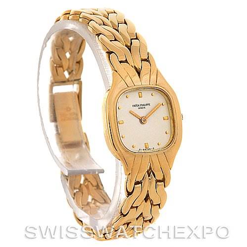 This is a side-angle view of a Vintage Patek Philippe watch, showcasing its gold bracelet and rectangular dial.