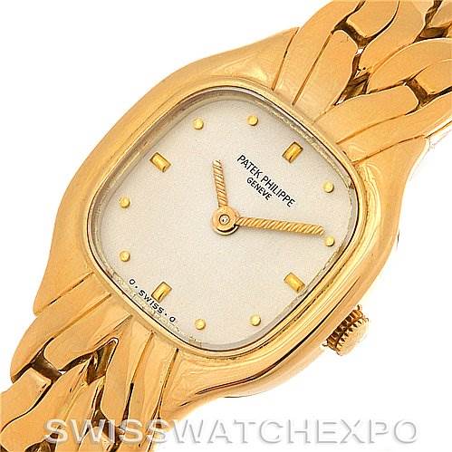 The image shows a top view of a vintage Patek Philippe watch, highlighting its rectangular gold case, dial, hands, and bracelet.