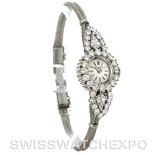 The image shows a side and slight front angle of the Vintage Patek Philippe watch with a detailed view of its bracelet and diamond-studded case.