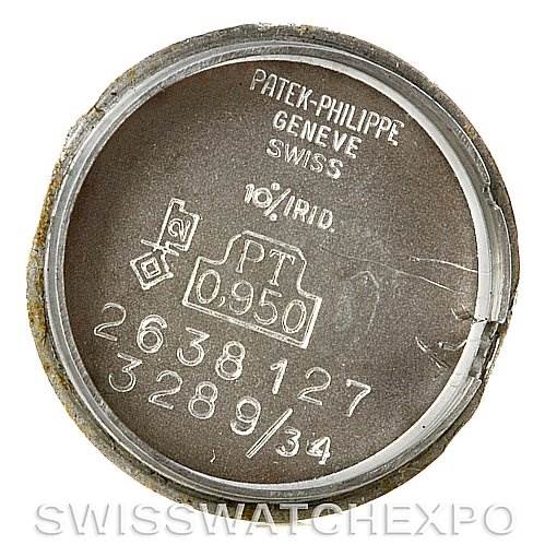 The image shows the inner case back of a vintage Patek Philippe watch, displaying engravings and hallmarks.