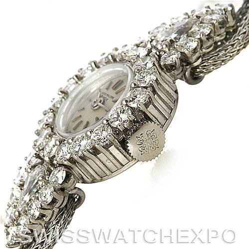 The image shows a side angle of a Vintage Patek Philippe watch, highlighting its crown, diamond bezel, and part of the bracelet.