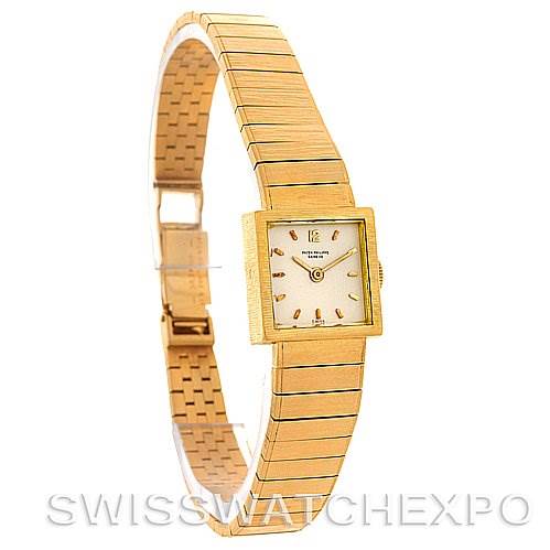 This image shows a side angle of the Patek Philippe Vintage 3285/23 Women's Yellow Gold Silver Dial 3285/23 Women's Yellow Gold Silver Dial model watch, highlighting its golden bracelet, square dial, and clasp.