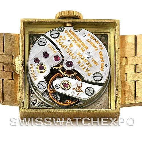 This image shows the open case back of a Vintage Patek Philippe watch, revealing its intricate mechanical movement components.
