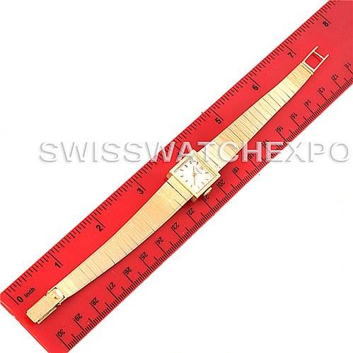 The image shows a Patek Philippe Vintage 3285/23 Women's Yellow Gold Silver Dial 3285/23 Women's Yellow Gold Silver Dial model watch at a top-down angle, placed next to a red ruler for size reference.