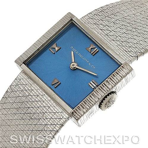 This image shows a vintage Patek Philippe watch with a blue square dial, Roman numerals, and a textured silver-toned bracelet at a slight angle.