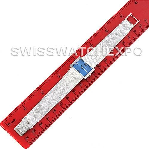 This image shows a top view of a vintage Patek Philippe watch, positioned next to a red ruler for scale.