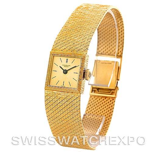The image shows a side angle of a Vintage Patek Philippe watch, highlighting its rectangular face, crown, and gold mesh bracelet.