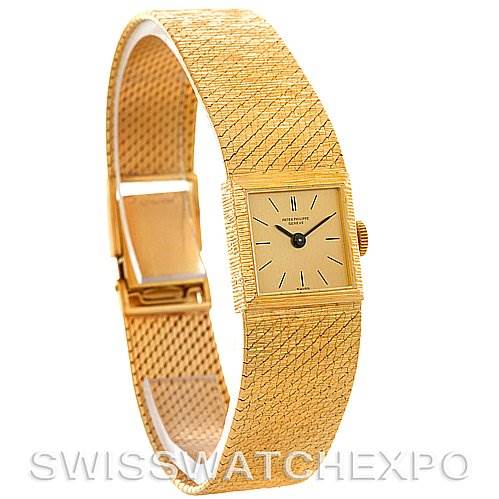The image shows a Vintage Patek Philippe watch from a 3/4 angle, highlighting the square face, gold bracelet, and clasp.