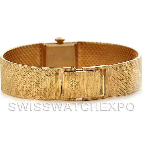 This image shows a vintage Patek Philippe watch bracelet from a rear angle, highlighting its clasp and textured gold band.