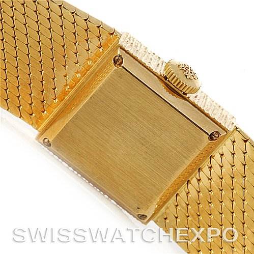 The image shows the back cover and part of the bracelet of a Vintage Patek Philippe watch, with a focus on the crown and caseback.