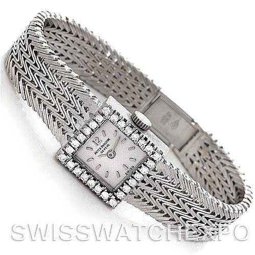 The image shows a side view of a Vintage Patek Philippe watch, highlighting its bracelet, dial, and diamond-encrusted bezel.
