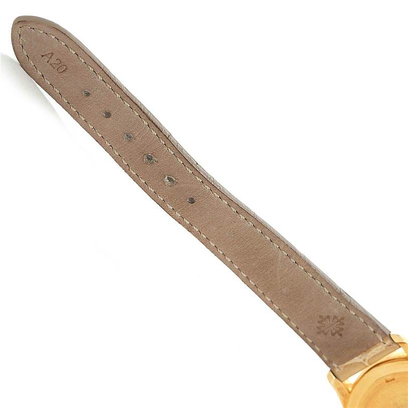 The image shows the leather strap and partial gold case of a Patek Philippe 4906J Women's Yellow Gold White Dial 4906J Women's Yellow Gold White Dial 18k Yellow Gold Ladies Watch, model 4906J.