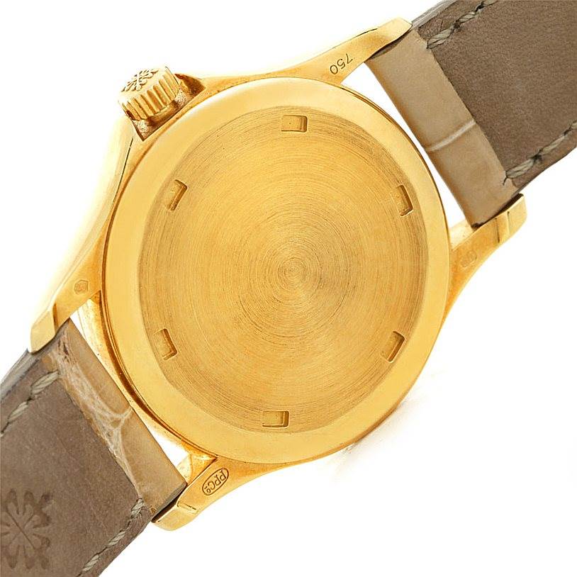 The image shows the back view of the Patek Philippe 4906J Women's Yellow Gold White Dial 4906J Women's Yellow Gold White Dial 18k Yellow Gold Ladies Watch 4906J, highlighting the case and part of the strap.