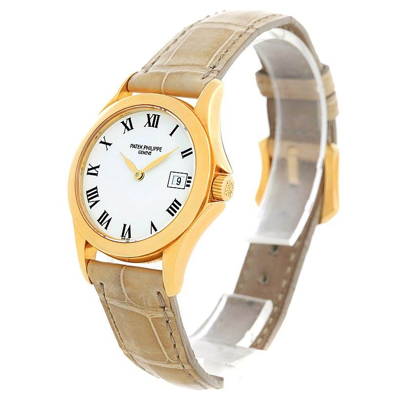 The image shows a Patek Philippe 4906J Women's Yellow Gold White Dial 4906J Women's Yellow Gold White Dial 4906J Ladies Watch in 18k Yellow Gold from a three-quarter front angle, detailing the dial, bezel, and strap.