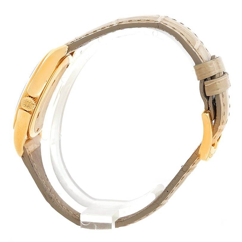 This image shows a side view of the Patek Philippe 4906J Women's Yellow Gold White Dial 4906J Women's Yellow Gold White Dial 4906J 18k Yellow Gold Ladies Watch, focusing on the case, crown, and strap.