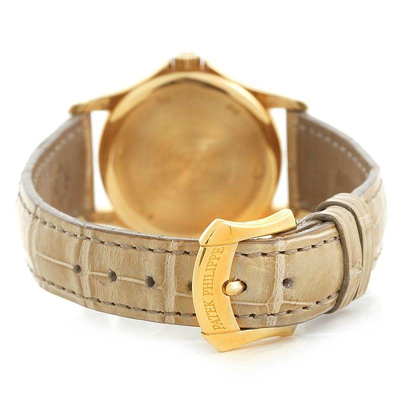 The image shows the back view of the Patek Philippe 4906J Women's Yellow Gold White Dial 4906J Women's Yellow Gold White Dial 18k Yellow Gold Ladies Watch 4906J, highlighting the clasp and leather strap.