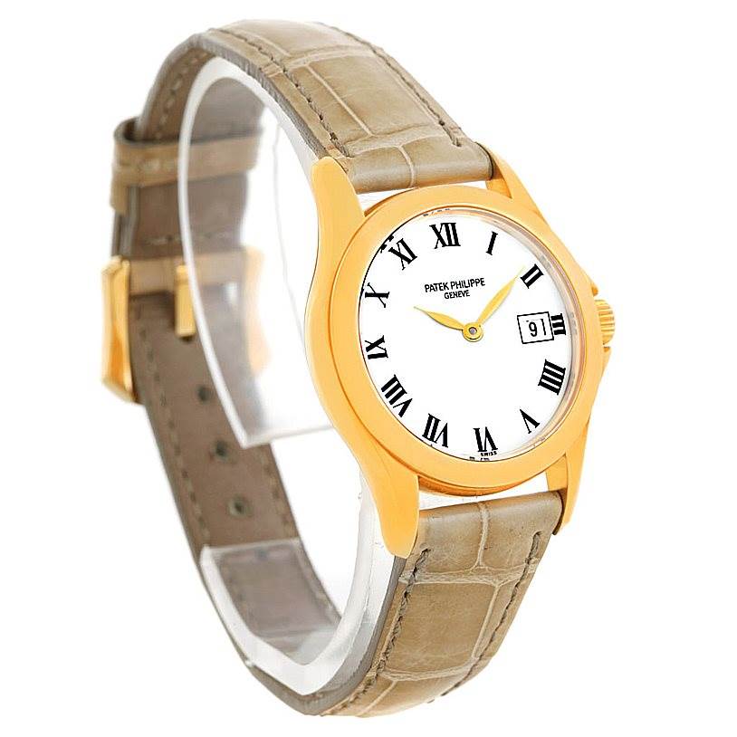 The image shows a Patek Philippe 4906J Women's Yellow Gold White Dial 4906J Women's Yellow Gold White Dial 4906J 18k Yellow Gold Ladies Watch at a three-quarter angle displaying the face, strap, and side details.