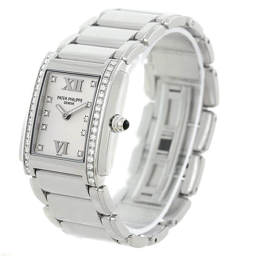 The Patek Philippe Twenty-4 4910/10A-011 Women's Stainless Steel Silver Dial 4910/10A-011 Women's Stainless Steel Silver Dial watch is shown from an oblique angle highlighting its rectangular face, diamond bezel, and bracelet.