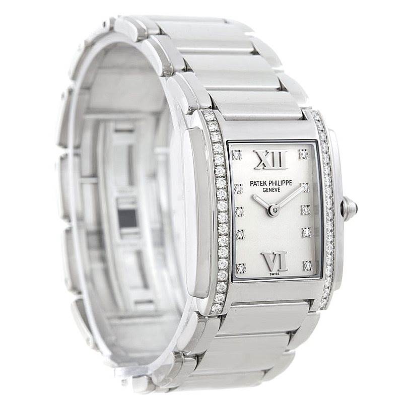 The image shows a Patek Philippe Twenty-4 4910/10A-011 Women's Stainless Steel Silver Dial 4910/10A-011 Women's Stainless Steel Silver Dial watch viewed from an angled close-up, highlighting the dial, bezel, and metal bracelet.