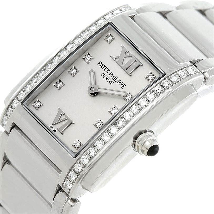 This image shows a close-up of a Patek Philippe Twenty-4 4910/10A-011 Women's Stainless Steel Silver Dial 4910/10A-011 Women's Stainless Steel Silver Dial watch's case, dial, bracelet, and crown from a side angle.