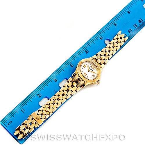 The image shows a Patek Philippe Neptune 4881 Women's Yellow Gold Beige Dial 4881 Women's Yellow Gold Beige Dial model watch placed alongside a blue ruler for scale.