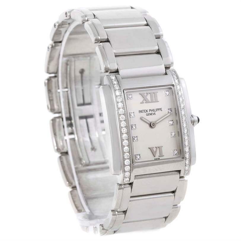 The image shows a front angled view of a Patek Philippe Twenty-4 4910/10A-011 Women
s Stainless Steel Silver Dial 4910/10A-011 Women
s Stainless Steel Silver Dial watch, displaying its rectangular face, bracelet, and diamond accents.