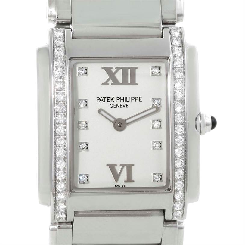 The image shows a front view of a Patek Philippe Twenty-4 4910/10A-011 Women
s Stainless Steel Silver Dial 4910/10A-011 Women
s Stainless Steel Silver Dial watch, highlighting its diamond-set bezel and dial.
