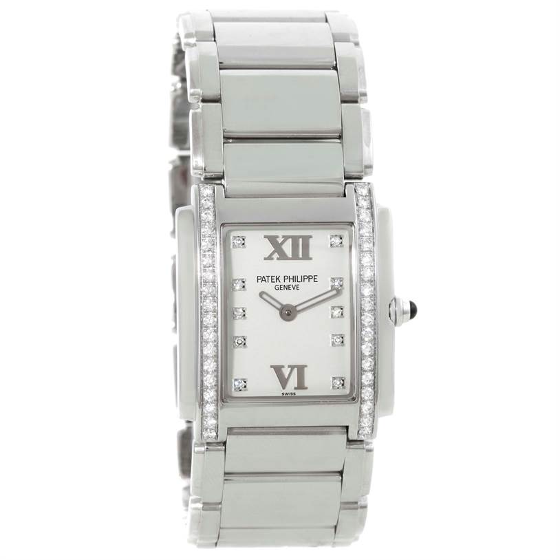 The image shows a front view of the Patek Philippe Twenty-4 4910/10A-011 Women
s Stainless Steel Silver Dial 4910/10A-011 Women
s Stainless Steel Silver Dial watch, highlighting its rectangular face, diamond accents, and metal bracelet.