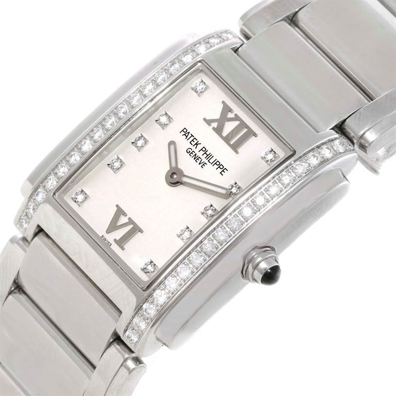 This image shows a close-up, diagonal view of the Patek Philippe Twenty-4 4910/10A-011 Women
s Stainless Steel Silver Dial 4910/10A-011 Women
s Stainless Steel Silver Dial watch face, bezel, crown, and bracelet.