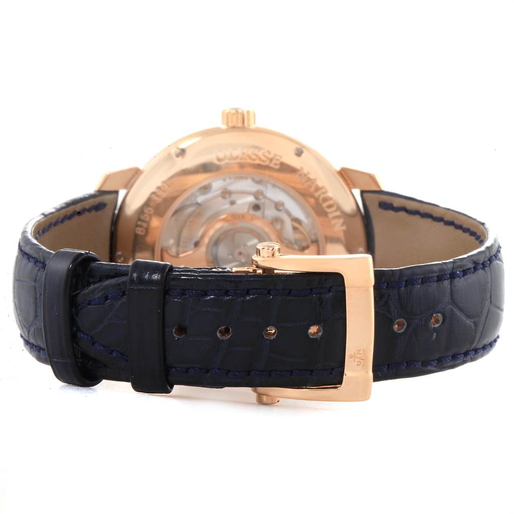 The image shows the back view of the Ulysse Nardin Classico 8156-111-B-2 Men
s Rose Gold Blue Dial 8156-111-B-2 Men
s Rose Gold Blue Dial watch, highlighting the strap, buckle, and transparent case back.