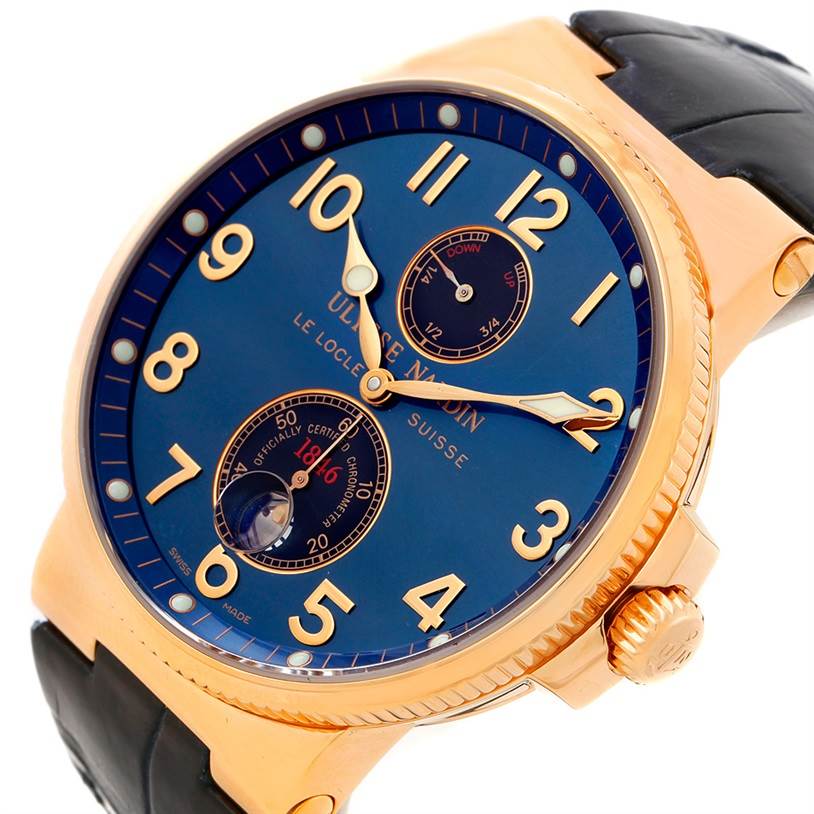 The Ulysse Nardin Marine 266-66 Men's Rose Gold Blue Dial 266-66 Men's Rose Gold Blue Dial watch is shown at an angle displaying its blue dial, gold accents, bezel, and black leather strap.