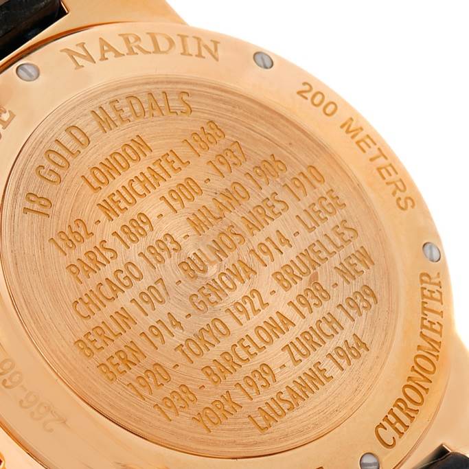 The image shows the back of a Ulysse Nardin Marine 266-66 Men's Rose Gold Blue Dial 266-66 Men's Rose Gold Blue Dial watch, highlighting its engravings and gold medal achievements.