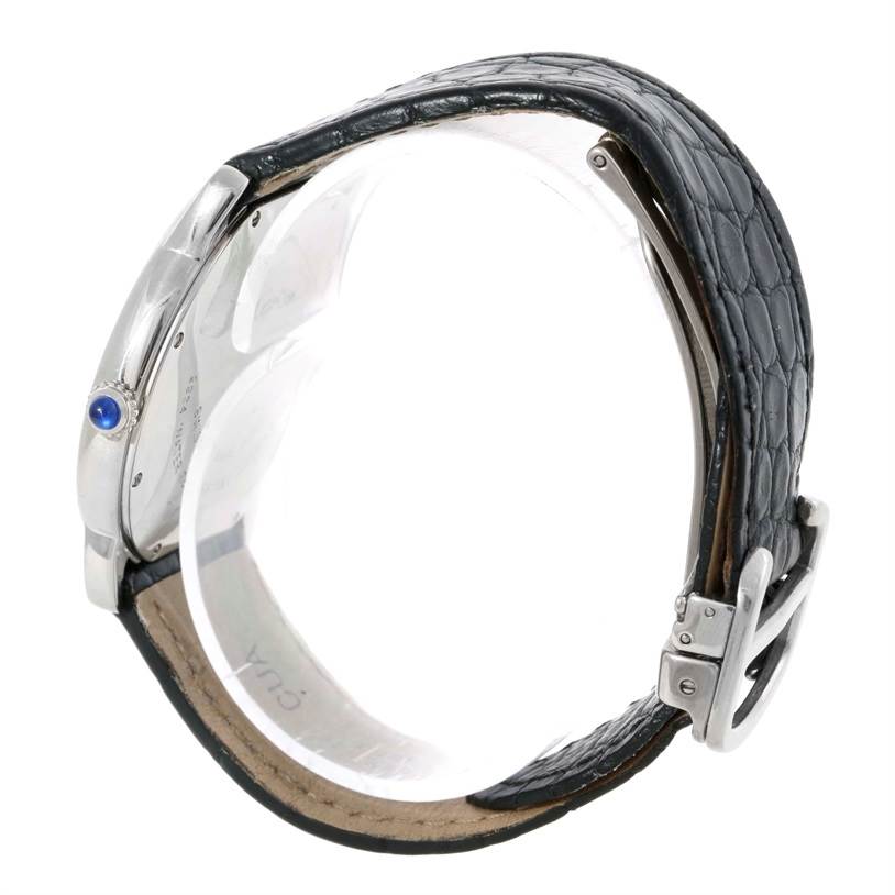 This image shows the side view of a Cartier Ronde W6700255 Stainless Steel Silver Dial W6700255 Stainless Steel Silver Dial watch, featuring its leather strap, buckle, and crown with a blue cabochon.