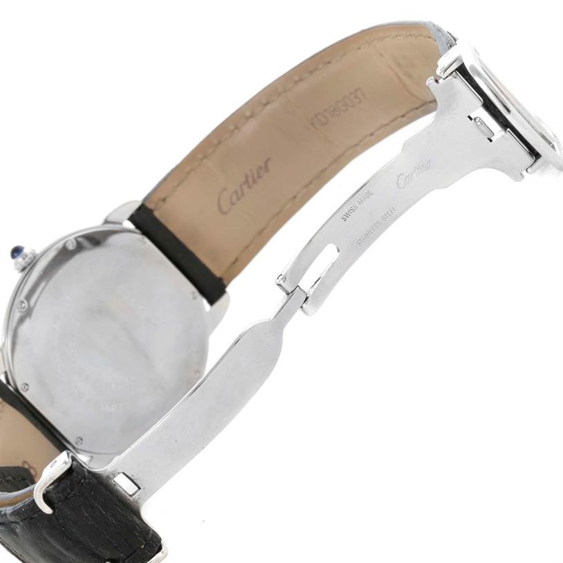 The image shows the back of a Cartier Ronde W6700255 Men's Stainless Steel Silver Dial W6700255 Men's Stainless Steel Silver Dial watch and its partially opened leather strap and clasp.