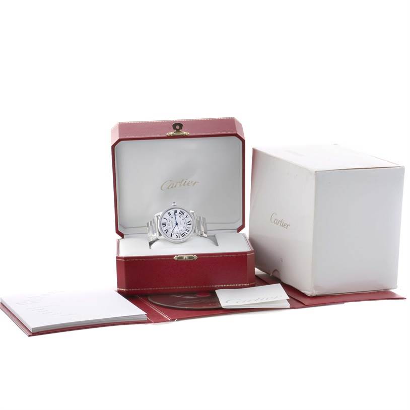 A Cartier Ronde W6701011 Men's Stainless Steel Silver Dial W6701011 Men's Stainless Steel Silver Dial watch is displayed from the front, inside its red box, with additional packaging and booklets shown.