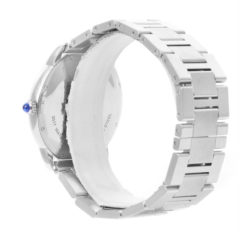 The image shows the back and side of a Cartier Ronde W6701011 Men
s Stainless Steel Silver Dial W6701011 Men
s Stainless Steel Silver Dial model watch, highlighting its bracelet and crown with a blue cabochon.