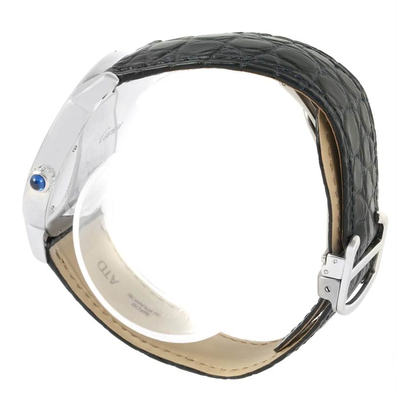 The image shows a side view of the Cartier Ronde W6701010 Men
s Stainless Steel Silver Dial W6701010 Men
s Stainless Steel Silver Dial watch, highlighting the bezel, crown with blue cabochon, and black leather strap.