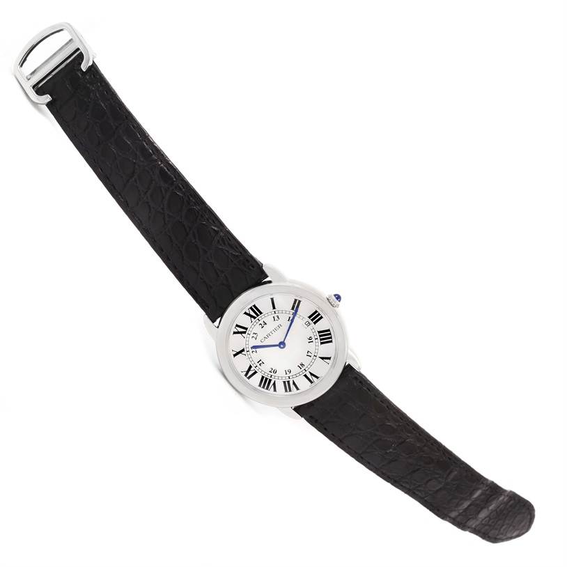 The image shows a top-down view of a Cartier Ronde W6700255 Stainless Steel Silver Dial W6700255 Stainless Steel Silver Dial model watch, featuring a round dial and black leather strap.