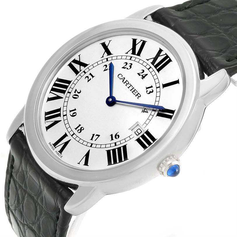 The Cartier Ronde W6700255 Stainless Steel Silver Dial W6700255 Stainless Steel Silver Dial watch is shown at an angle displaying the dial, Roman numerals, blue hands, crown with blue cabochon, and black leather strap.