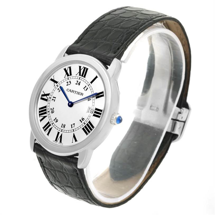 The Cartier Ronde W6700255 Stainless Steel Silver Dial W6700255 Stainless Steel Silver Dial watch is shown at an angle displaying its face, black strap, and side crown with a blue gemstone.